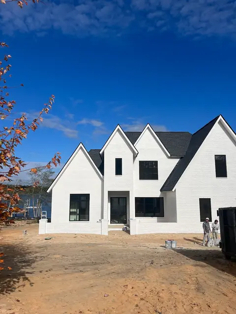 Two-story white house exterior with black windows, from Kelli Conner’s Google review