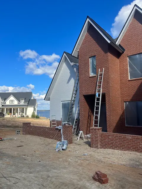 Brick house exterior with ladders set up during the work, from Kelli Conner’s Google review