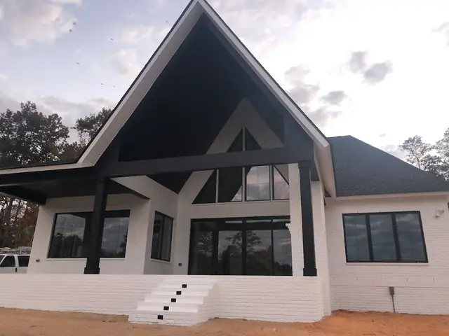 White house with a dark peaked porch roof, from Kelli Conner’s Google review