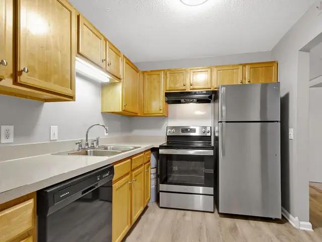 Apartment kitchen with wood cabinets and stainless appliances, from Wanda Harland’s Google review